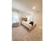Light-filled bedroom with plush carpeting, neutral décor, and ample natural light from large windows at 2915 Turnstone, St Cloud, FL 34773