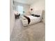 Bedroom with neutral carpet, natural light, simple desk, and comfortable padded headboard at 2915 Turnstone, St Cloud, FL 34773