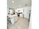 Modern kitchen featuring a spacious island, white cabinets, and stainless steel appliances at 2915 Turnstone, St Cloud, FL 34773
