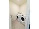 Bright laundry room features a modern washer and dryer set with tile flooring at 2915 Turnstone, St Cloud, FL 34773
