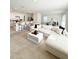 Open-concept living room featuring plush sofa, neutral decor, and a seamless flow to the kitchen at 2915 Turnstone, St Cloud, FL 34773