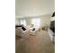 Spacious living room with neutral carpet, white sectional, and a wall-mounted TV at 2915 Turnstone, St Cloud, FL 34773