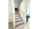 Carpeted staircase with white banister and natural light from nearby windows at 2915 Turnstone, St Cloud, FL 34773