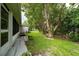 Spacious backyard features green grass, shade trees and a bench at 3161 Timberly Ln, Lakeland, FL 33810