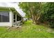 Spacious backyard features green grass, shade trees and a bench at 3161 Timberly Ln, Lakeland, FL 33810