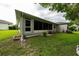View of the rear exterior of the home, showing the lanai and shaded backyard at 3161 Timberly Ln, Lakeland, FL 33810