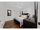 Comfortable bedroom with dark wood furniture, hardwood floors, and a ceiling fan at 3161 Timberly Ln, Lakeland, FL 33810