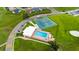 Aerial shot of a community pool and tennis courts, perfect for recreation and relaxation at 3161 Timberly Ln, Lakeland, FL 33810
