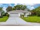 Charming single-story home featuring a manicured lawn and a two-car garage at 3161 Timberly Ln, Lakeland, FL 33810
