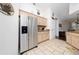 Bright kitchen with stainless steel refrigerator, light cabinets, and tile floors at 3161 Timberly Ln, Lakeland, FL 33810
