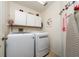 Laundry room complete with appliances and cabinets at 3161 Timberly Ln, Lakeland, FL 33810