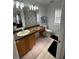 Well-lit bathroom with a large mirror, vanity, and standard toilet at 324 Palermo St, Davenport, FL 33897