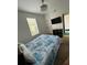 Bright bedroom with a large window, ceiling fan, and closet with ensuite access to the bathroom at 324 Palermo St, Davenport, FL 33897