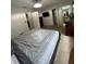 Spacious carpeted bedroom with a ceiling fan, large bed, and connecting bathroom and closet at 324 Palermo St, Davenport, FL 33897