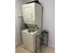 Practical laundry space featuring stacked washer and dryer units, and additional storage options at 324 Palermo St, Davenport, FL 33897