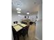 Open-concept living area with modern lighting, tile flooring, and a seamless flow to the dining space at 324 Palermo St, Davenport, FL 33897