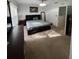 Spacious primary bedroom with soft carpet, natural light, and an ensuite bathroom and dresser at 324 Palermo St, Davenport, FL 33897