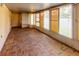 Spacious sunroom with brick flooring and multiple awning windows for ample natural light at 3267 Villa Way Cir, St Cloud, FL 34769