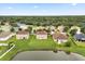 An aerial view highlights the home's setting with a large yard and pond, nestled in a vibrant community at 3335 Whistling Trl, St Cloud, FL 34772