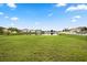 Picture of large backyard with grass and a pond in a residential neighborhood at 3335 Whistling Trl, St Cloud, FL 34772