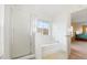 Bright ensuite bathroom with a shower, soaking tub, and access to the spacious main bedroom at 3335 Whistling Trl, St Cloud, FL 34772