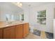 Bright bathroom with double sink vanity, toilet, decorative mirror and a window at 3335 Whistling Trl, St Cloud, FL 34772