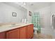 Bathroom featuring a vanity with sink, toilet, shower, and neutral color scheme at 3335 Whistling Trl, St Cloud, FL 34772