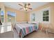 Bright bedroom with ceiling fan, plenty of natural light from dual windows, and neutral decor at 3335 Whistling Trl, St Cloud, FL 34772