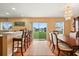 Bright dining area with barstool seating, and sliding glass doors that open to a scenic outdoor view at 3335 Whistling Trl, St Cloud, FL 34772
