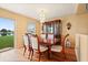Elegant dining room with a classic wood table, chandelier, and natural light, perfect for gatherings at 3335 Whistling Trl, St Cloud, FL 34772