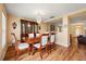 Elegant dining room featuring a beautiful table set, chandelier, and wood floors, great for entertaining at 3335 Whistling Trl, St Cloud, FL 34772