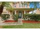 Charming home featuring a covered front porch with stylish columns and well-maintained landscaping at 3335 Whistling Trl, St Cloud, FL 34772