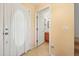 Hallway view of a bathroom with a light, tiled floors, and peach painted walls at 3335 Whistling Trl, St Cloud, FL 34772