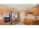 Kitchen with stainless steel appliances, wooden cabinets, and efficient layout at 3335 Whistling Trl, St Cloud, FL 34772