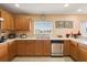 Bright kitchen features light wood cabinets, stainless steel appliances, and a view to the outside at 3335 Whistling Trl, St Cloud, FL 34772