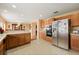 Kitchen featuring wooden cabinets, stainless steel appliances, and open access to the dining room at 3335 Whistling Trl, St Cloud, FL 34772