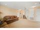 Large living room with neutral carpet, ceiling lights, and staircase access at 3335 Whistling Trl, St Cloud, FL 34772