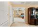 Living room with neutral carpet, television, and doorway leading to bedroom at 3335 Whistling Trl, St Cloud, FL 34772