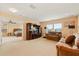 Bright living room with comfortable seating, entertainment center, and view to the bedroom through doorway at 3335 Whistling Trl, St Cloud, FL 34772