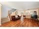 Open-concept living area with wood floors, a cozy sofa, and staircase access to the upper level at 3335 Whistling Trl, St Cloud, FL 34772