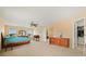 Spacious main bedroom featuring neutral walls, ceiling fan, carpet floors, and ensuite bath and walk-in closet at 3335 Whistling Trl, St Cloud, FL 34772