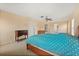Spacious main bedroom featuring neutral walls, ceiling fan, carpet floors, and ensuite bath and walk-in closet at 3335 Whistling Trl, St Cloud, FL 34772