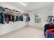 Walk-in closet with ample storage space, with built-in shelving and hanging rods for organization at 3335 Whistling Trl, St Cloud, FL 34772