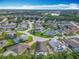 Aerial view shows a residential neighborhood with ponds and lush green trees from above at 341 Whittier St, Davenport, FL 33896