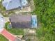 Birds-eye view of a home with a screened-in pool enclosure surrounded by landscaping at 341 Whittier St, Davenport, FL 33896