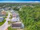 Aerial view showcases a residential neighborhood backing up to lush green trees from above at 341 Whittier St, Davenport, FL 33896