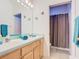 Bathroom with double sinks and a shower with a curtain at 341 Whittier St, Davenport, FL 33896