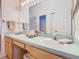 Bright bathroom featuring a dual sink vanity, mirror, and ample counter space at 341 Whittier St, Davenport, FL 33896
