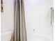 Bathroom with tub/shower and a grey curtain at 341 Whittier St, Davenport, FL 33896