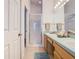 A bathroom with a walk-in shower, dual sink vanity, and ample lighting at 341 Whittier St, Davenport, FL 33896